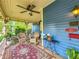 Charming porch with blue siding, ceiling fan, rocking chairs, and a patterned rug at 420 S Oak Ave, Sanford, FL 32771