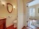 Cozy half-bathroom with a vintage sink, paneled walls, and hardwood floors at 420 S Oak Ave, Sanford, FL 32771