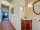 Half-bathroom featuring wood-like sink, paneled walls, and hardwood floors at 420 S Oak Ave, Sanford, FL 32771