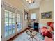Charming sitting room with french doors to balcony, mini fridge and shelving, perfect for relaxing or entertaining at 420 S Oak Ave, Sanford, FL 32771