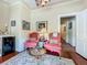 Bright sitting room with charming decor, mini-fridge, decorative rug, and access to other areas of the home at 420 S Oak Ave, Sanford, FL 32771