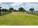 Large fenced backyard, with partial view of the lake at 6268 Great Bear Dr, Lakeland, FL 33805