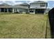 Large fenced backyard featuring grassy lawn and view of neighboring properties at 6268 Great Bear Dr, Lakeland, FL 33805