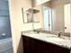 Bathroom featuring granite countertop, double sinks, and tiled shower at 6268 Great Bear Dr, Lakeland, FL 33805