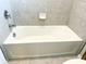 Clean bathtub with white porcelain and tile surround at 6268 Great Bear Dr, Lakeland, FL 33805