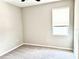 Neutral bedroom with light-colored walls, carpet, and window at 6268 Great Bear Dr, Lakeland, FL 33805