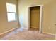 Cozy bedroom with neutral carpet, a window for natural light, and closet space at 6268 Great Bear Dr, Lakeland, FL 33805