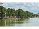 Scenic lakeside view featuring lush trees lining the water's edge, reflecting a serene and peaceful setting at 6268 Great Bear Dr, Lakeland, FL 33805