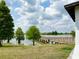 Picturesque lake with a wooden pier for fishing, enhanced by lush green trees and grassy banks at 6268 Great Bear Dr, Lakeland, FL 33805