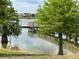 Scenic view of the lake, featuring a wooden pier, with lush trees enhancing the community's natural beauty at 6268 Great Bear Dr, Lakeland, FL 33805
