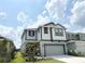 Two-story home featuring a two-car garage, a long driveway, and manicured landscaping in front of the house at 6268 Great Bear Dr, Lakeland, FL 33805
