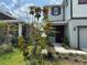 Charming two-story home featuring a landscaped front yard with a blooming magnolia tree and a welcoming red door at 6268 Great Bear Dr, Lakeland, FL 33805