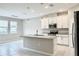 Modern kitchen with a large island, stainless steel appliances, and stylish pendant lighting at 6268 Great Bear Dr, Lakeland, FL 33805