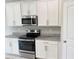 Well-equipped kitchen featuring modern appliances, granite countertops, and ample cabinet space at 6268 Great Bear Dr, Lakeland, FL 33805