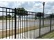 Close-up of the fenced backyard and lake view from the property at 6268 Great Bear Dr, Lakeland, FL 33805