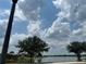 Scenic lake view with mature trees on a sunny day showcasing the tranquil community setting at 6268 Great Bear Dr, Lakeland, FL 33805
