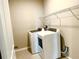 Modern laundry room with washer, dryer, and storage shelving for convenience at 6268 Great Bear Dr, Lakeland, FL 33805