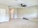 Spacious living room with neutral tones, tiled floor, and a modern ceiling fan at 6268 Great Bear Dr, Lakeland, FL 33805