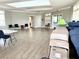 Large meeting room with gray walls, plank flooring, white doors, and multiple chairs and tables at 6268 Great Bear Dr, Lakeland, FL 33805