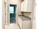 A pantry with granite countertops, white cabinets, and nearby hallway at 6268 Great Bear Dr, Lakeland, FL 33805