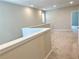 Bright upstairs hallway featuring plush carpeting and neutral paint at 6268 Great Bear Dr, Lakeland, FL 33805