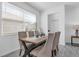 Bright dining room with wooden table, stylish chairs, and large window at 6328 Whip O Will Ln, St Cloud, FL 34771