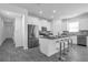 Spacious kitchen with island seating, stainless steel appliances, and modern gray accents at 6328 Whip O Will Ln, St Cloud, FL 34771