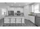 Open kitchen with island seating, stainless steel appliances, and sleek cabinetry at 6328 Whip O Will Ln, St Cloud, FL 34771
