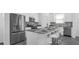 Modern kitchen with island seating, stainless steel appliances, and open layout at 6328 Whip O Will Ln, St Cloud, FL 34771
