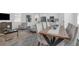 Open-concept living and dining area with modern furnishings and a view of the kitchen at 6328 Whip O Will Ln, St Cloud, FL 34771