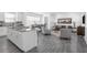 Bright, open-concept living room with modern furnishings, adjacent to a kitchen with stainless steel appliances at 6328 Whip O Will Ln, St Cloud, FL 34771