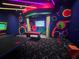 Vibrant arcade with vivid colors, fun patterns, neon lights, pool table, ping pong, and game stations at 639 Longboat Dr, Davenport, FL 33896