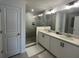 Modern bathroom with double vanity, sleek fixtures, and a glass-enclosed shower at 639 Longboat Dr, Davenport, FL 33896