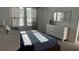 Comfortable bedroom with natural light, featuring a dresser and matching bedside lamps at 639 Longboat Dr, Davenport, FL 33896
