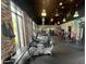 Well-equipped gym with treadmills, ellipticals, weights, and floor to ceiling windows with natural light at 639 Longboat Dr, Davenport, FL 33896