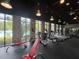 State-of-the-art gym featuring treadmills, ellipticals, weights, and floor to ceiling windows with natural light at 639 Longboat Dr, Davenport, FL 33896