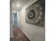 Neutral hallway with carpet and decorative wall art. Provides access to other rooms at 639 Longboat Dr, Davenport, FL 33896