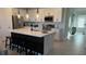 Modern kitchen features an island with bar seating and stainless appliances at 639 Longboat Dr, Davenport, FL 33896