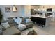 Open-concept living area with a modern kitchen island and dining table at 639 Longboat Dr, Davenport, FL 33896