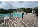 Community pool surrounded by lush landscaping, offering a serene place for relaxation and recreation at 639 Longboat Dr, Davenport, FL 33896