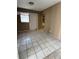 Bedroom features tiled floor with natural light from a window and access to the bathroom at 702 Willie Mays Pkwy, Orlando, FL 32811