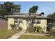 Charming stone-clad home featuring bright windows and a unique stone chimney detail at 702 Willie Mays Pkwy, Orlando, FL 32811