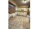 Kitchen area with tile flooring, offering potential for customization and renovation at 702 Willie Mays Pkwy, Orlando, FL 32811