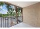 This screened patio provides outdoor living space with views of lush landscaping, and parking spaces at 7511 Seurat St # 10207, Orlando, FL 32819