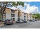 Exterior of the well-maintained apartment building featuring a neutral color scheme and ample parking at 7511 Seurat St # 10207, Orlando, FL 32819