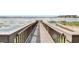Community wooden boardwalk and fishing dock overlooking a lake; perfect for walking, relaxing, or fishing at 7511 Seurat St # 10207, Orlando, FL 32819