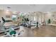 This fitness center features modern exercise equipment and a bright interior with views of lush landscaping at 7511 Seurat St # 10207, Orlando, FL 32819
