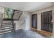 Hallway view leading to the apartment unit, featuring stairs and secure entry doors at 7511 Seurat St # 10207, Orlando, FL 32819