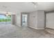 Light filled living room with neutral paint, tile entry, ceiling fan, and balcony access at 7511 Seurat St # 10207, Orlando, FL 32819