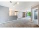 Bright living room features neutral paint, ceiling fan, shelving and sliding glass doors to the balcony at 7511 Seurat St # 10207, Orlando, FL 32819